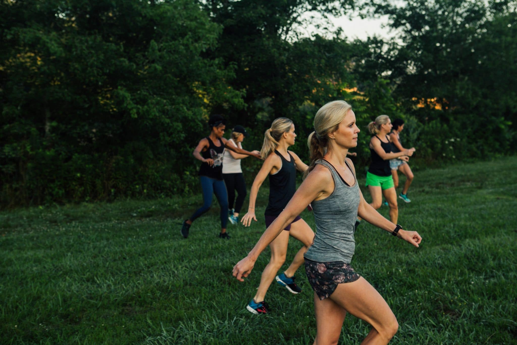 women doing running drills in a field