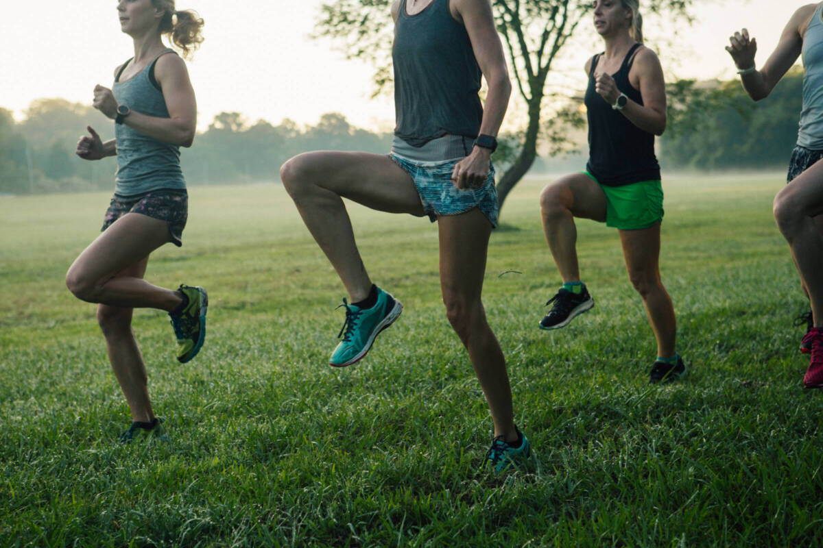 women doing running drills in field