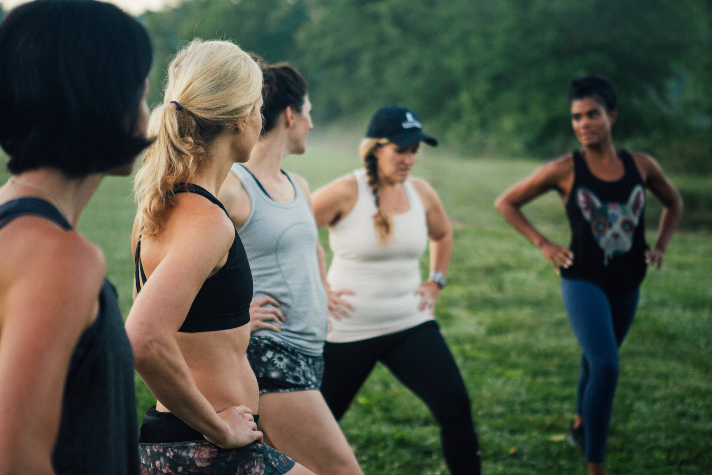 Women stretching in a field.