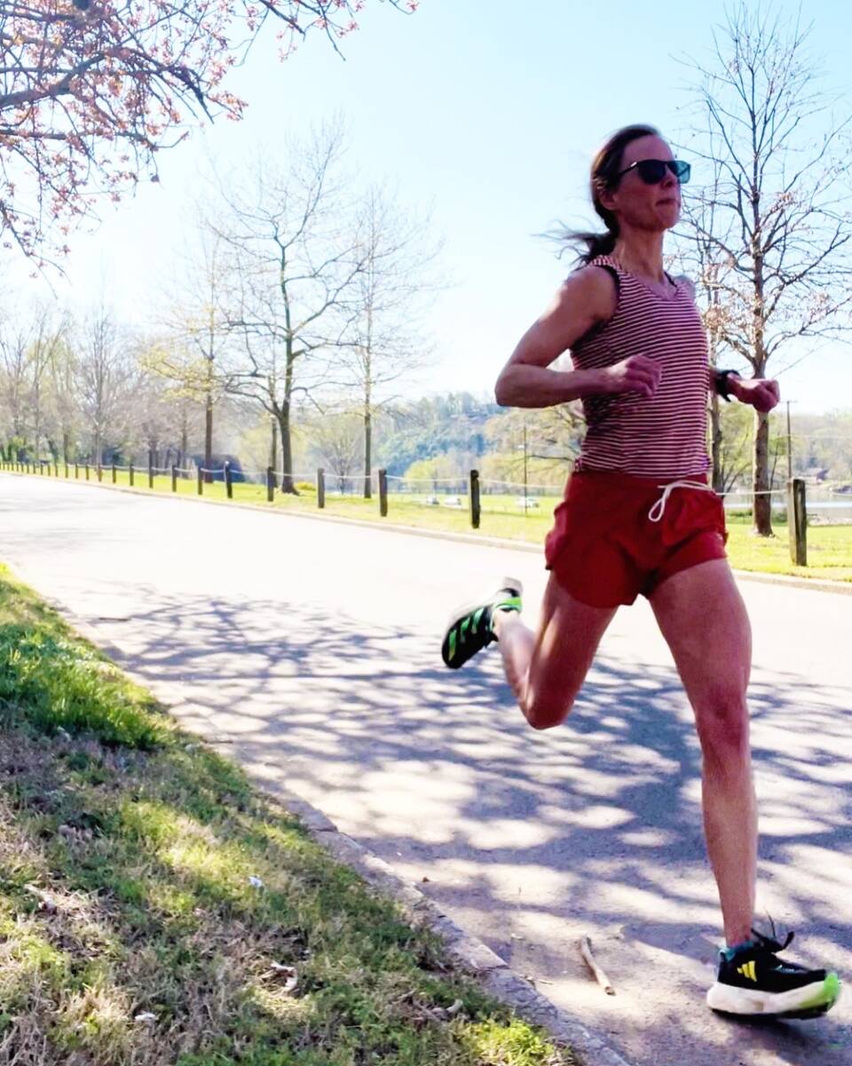 woman running strides on street