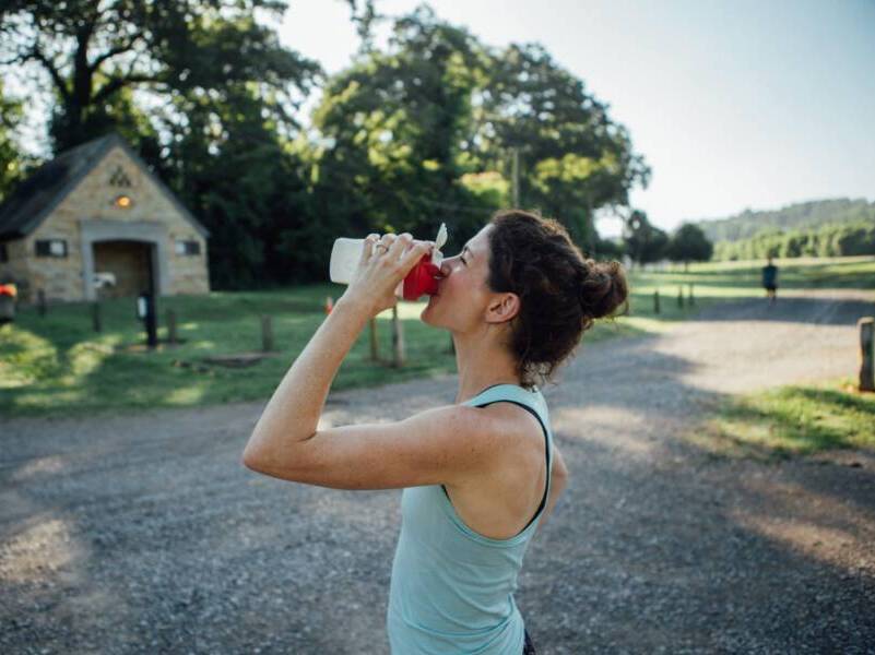 woman drinking from sports bottle