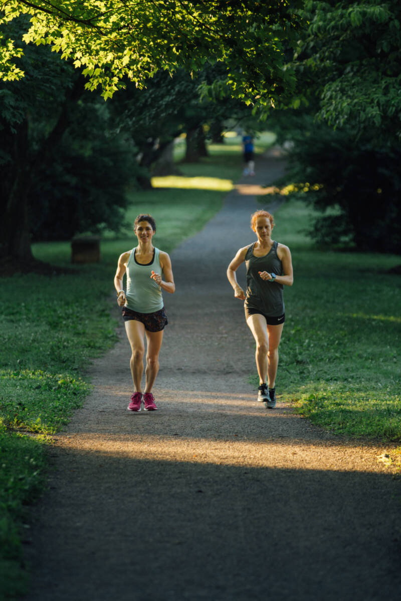 two women running on a path