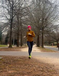 Whitney running in Fells turtleneck