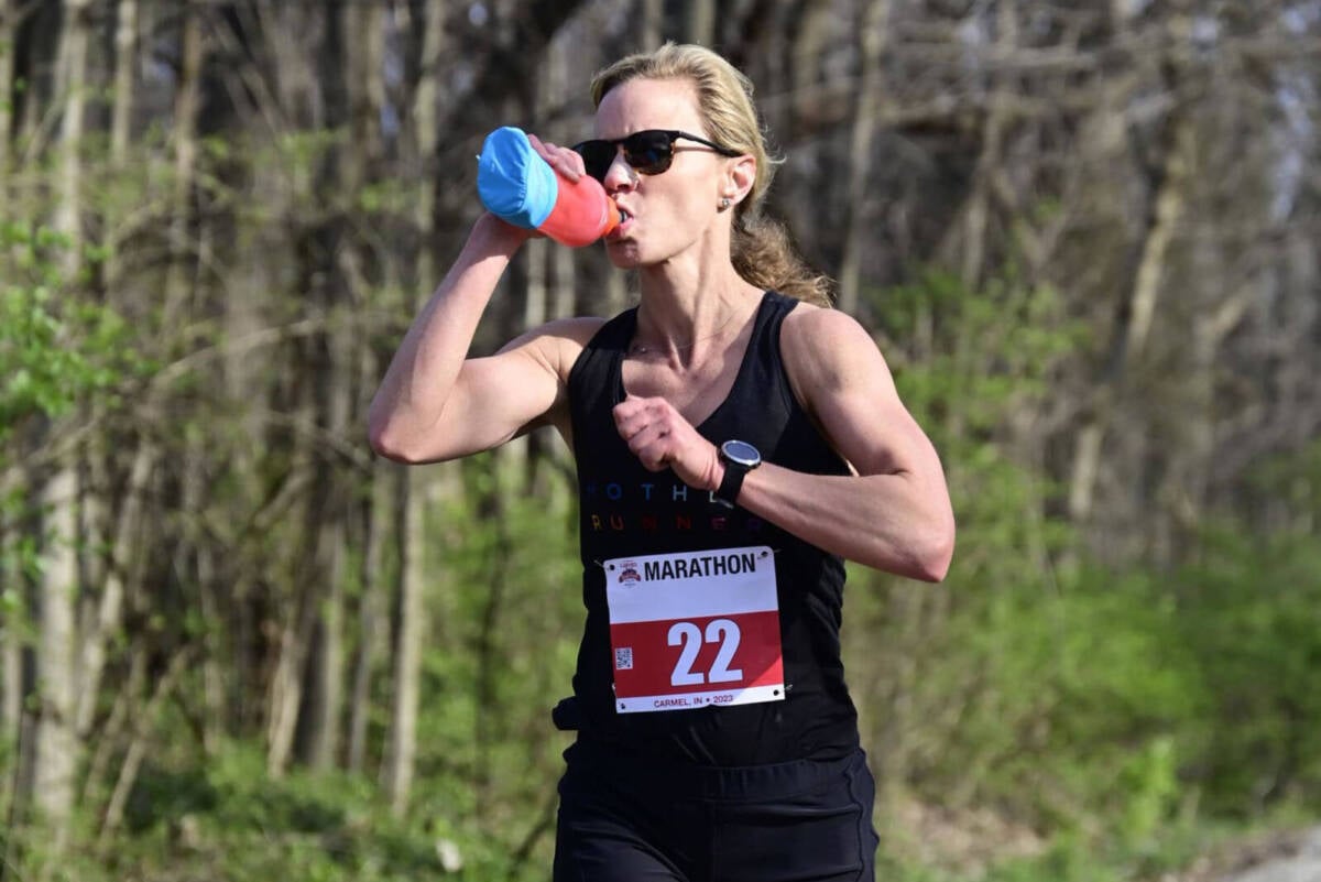 whitney drinking from bottle during marathon