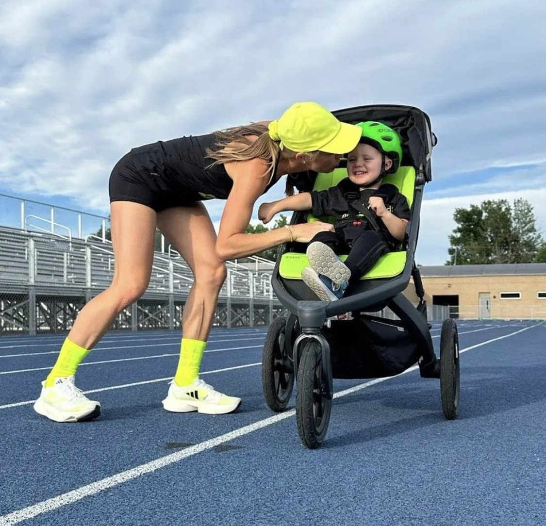 Neely Gracey kisses son Rome after setting the world record in the stroller mile.