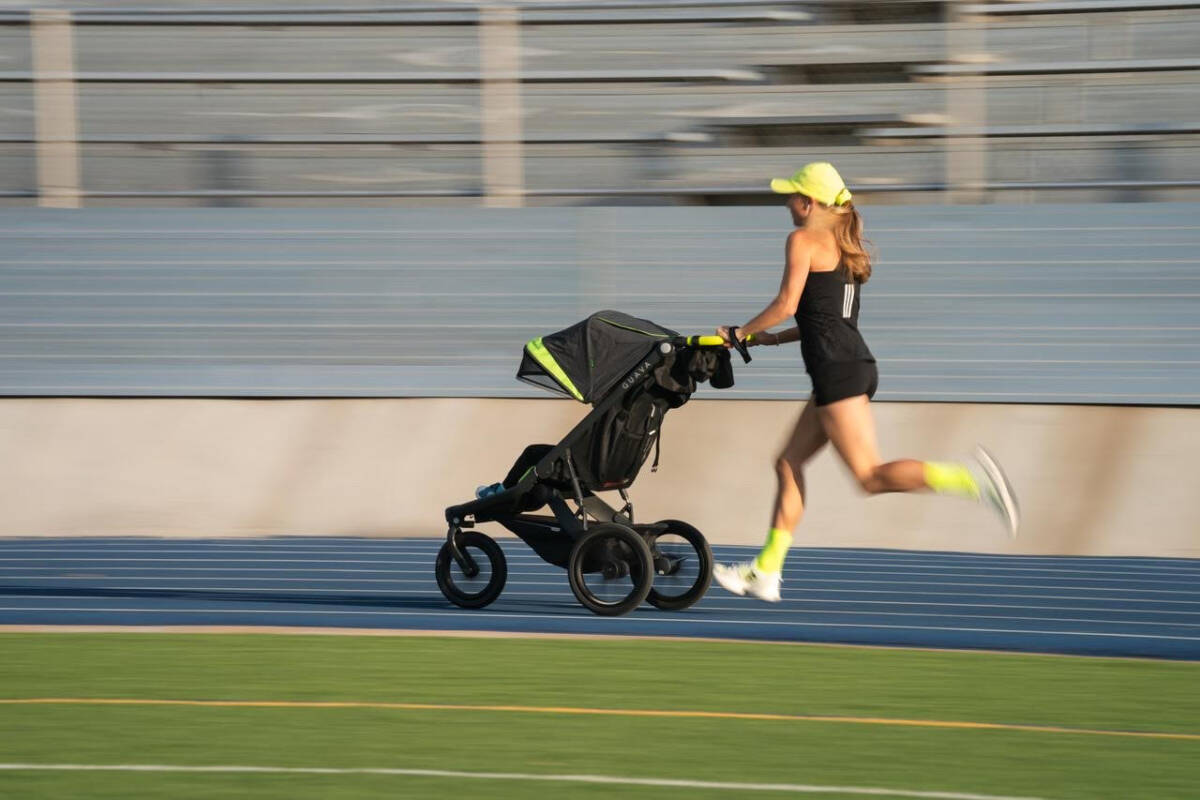 Neely Gracey sets the world record for the stroller mile in a time of 5:24. ushing stroller at track.