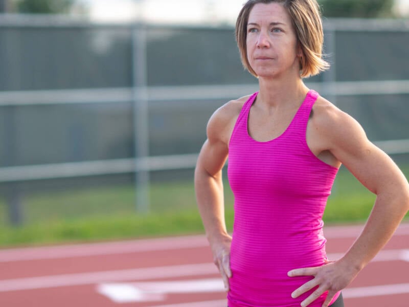 older woman in pink at track