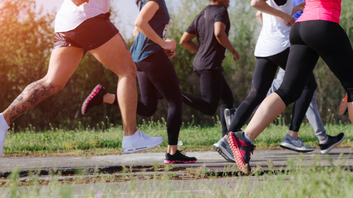 legs of runners running in a field