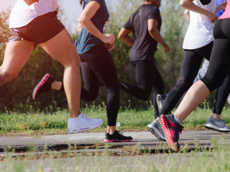 legs of runners running in a field