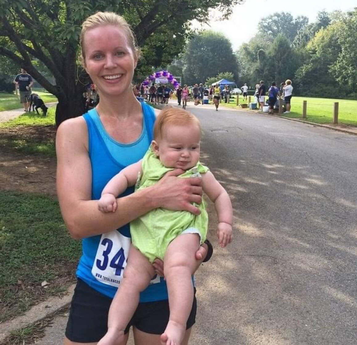 woman runner holding baby