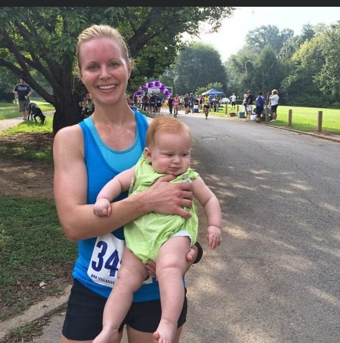 woman runner holding baby