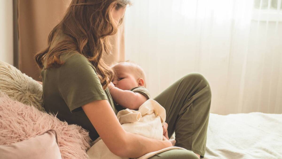 breastfeeding mom in chair with baby