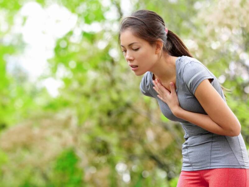 woman grabbing chest when running