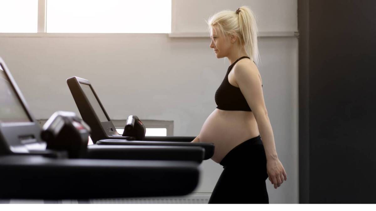 Pregnant woman walking on a treadmill.