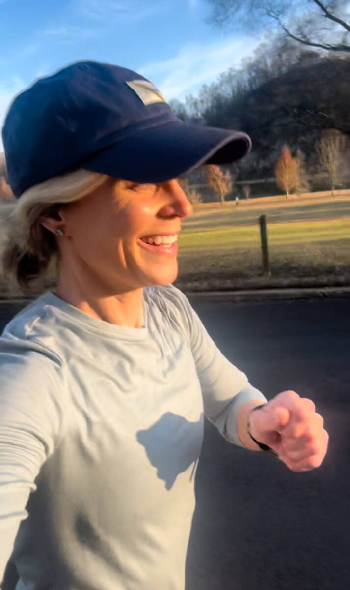 Whitney Heins running in blue hat