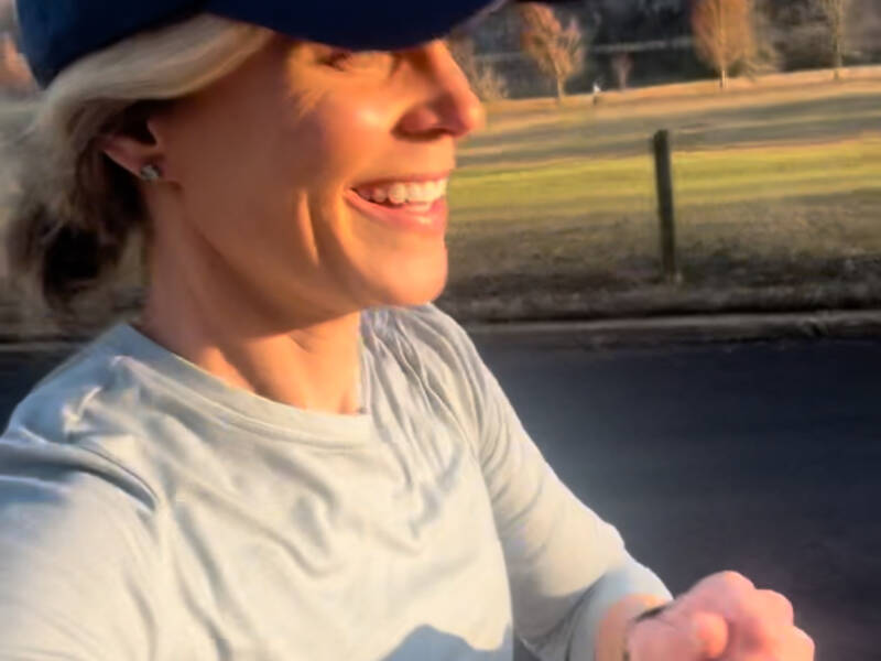 Whitney Heins running in blue hat