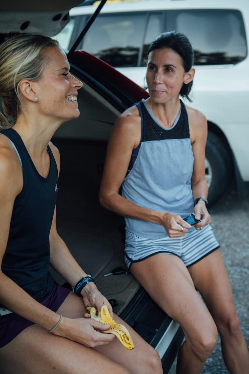 women eat on a tailgate