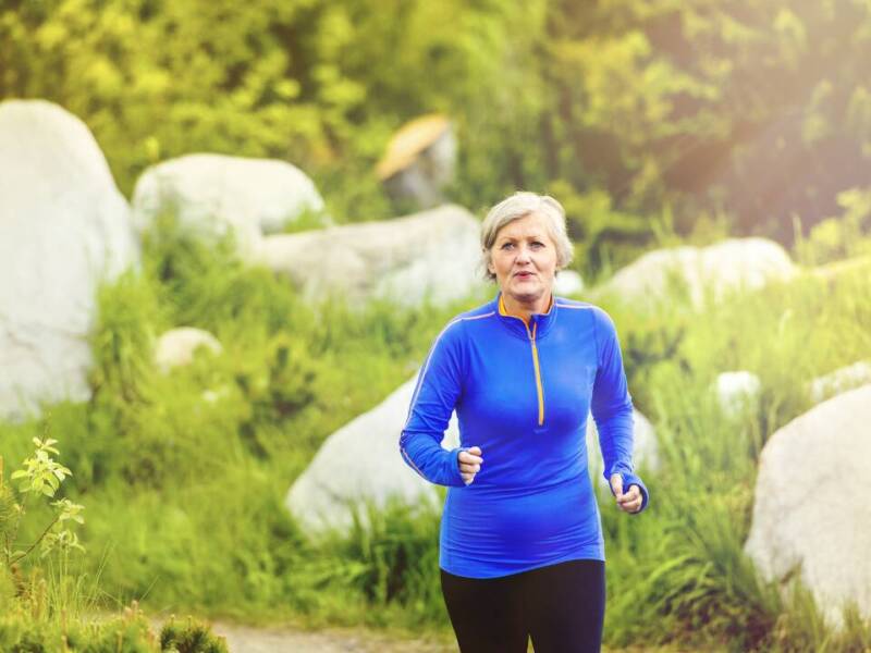 older woman running in blue