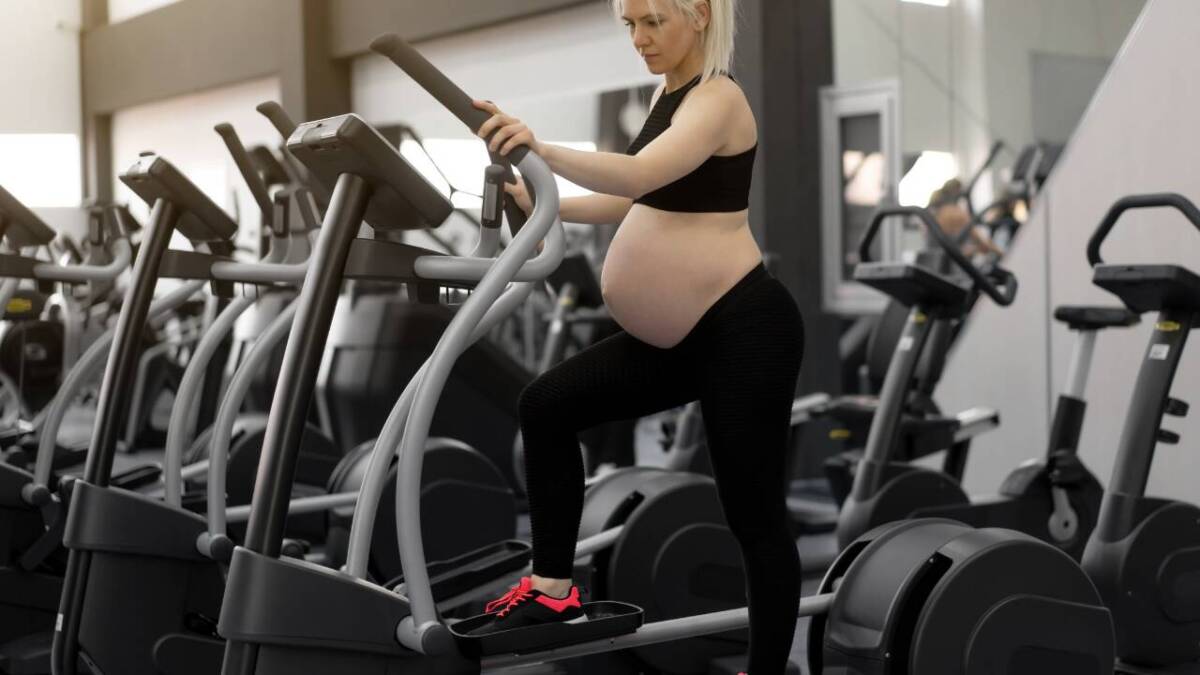 woman using the elliptical while pregnant