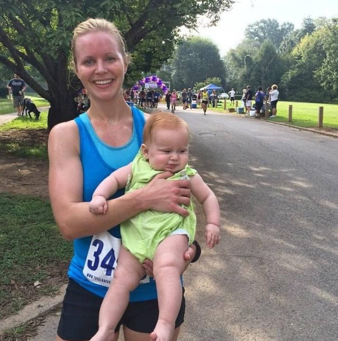 whitney with a baby at a race finish line